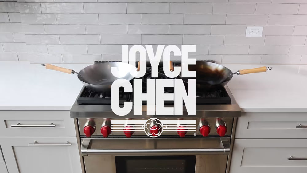 Load video: Joyce Chen wok seasoning guide: chef in blue apron seasons two pre-seasoned carbon steel woks on a black gas stove, with on-screen steps and a reminder to wash without soap.