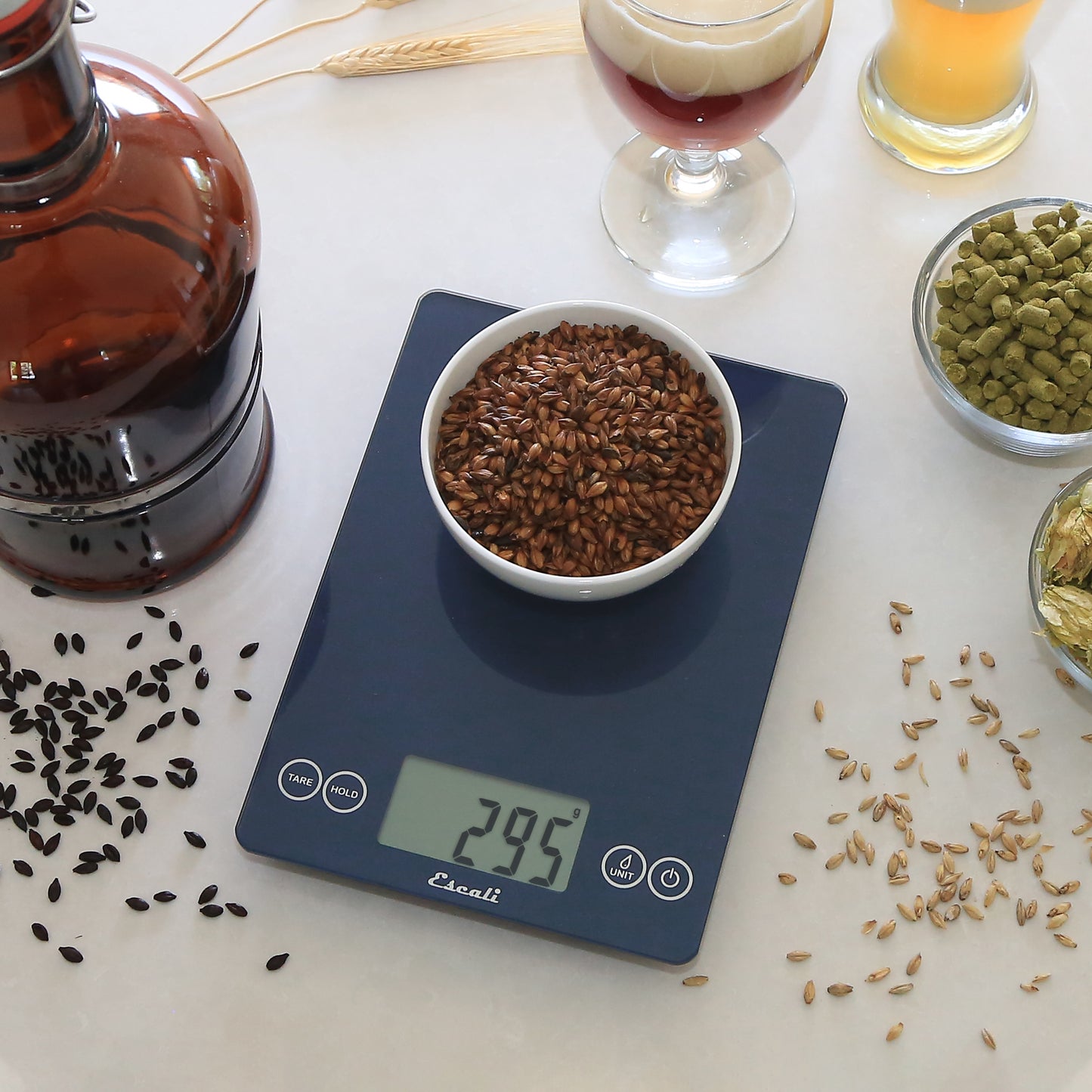 A lifestyle photo of an ARTI Digital Kitchen Scale weighing and surrounded by homebrew ingredients.